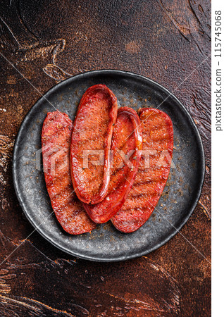 Grilled Turkish Sucuk meat sausage. Dark background. Top view Grilled Turkish Sucuk meat sausage. Dark background. Top view 115745068