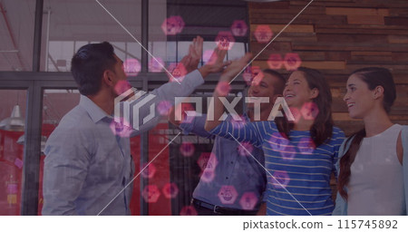 Image of icons floating over happy diverse coworkers clapping hands in office 115745892