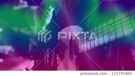 Image of glowing green and blue lights over mid section of caucasian man playing guitar Image of glowing green and blue lights over mid section of caucasian man playing guitar 115745969