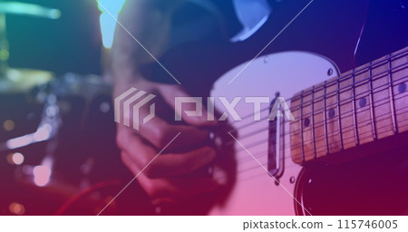 Image of rotating red light over slow motion hand of person playing electric guitar 115746005
