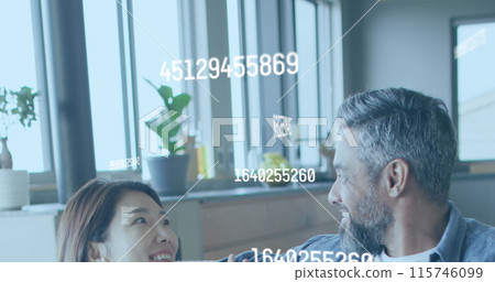 Image of numbers changing over diverse couple using laptop Image of numbers changing over diverse couple using laptop 115746099