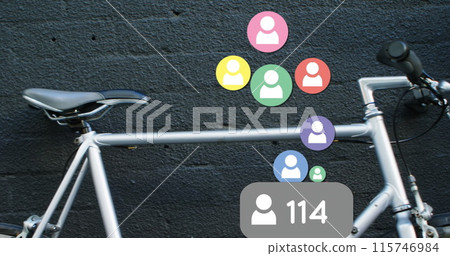 Close up of a parked bicycle is beside a black woman leaning on a brick wall drinking coffee Close up of a parked bicycle is beside a black woman leaning on a brick wall drinking coffee 115746984