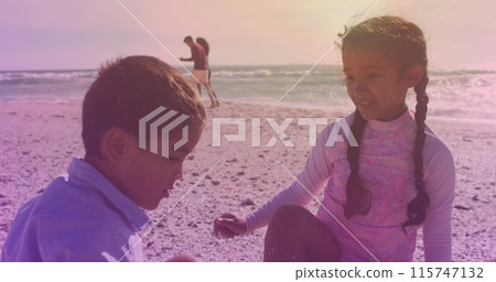 Spots of light against hispanic brother and sister high fiving each other at the beach Spots of light against hispanic brother and sister high fiving each other at the beach 115747132