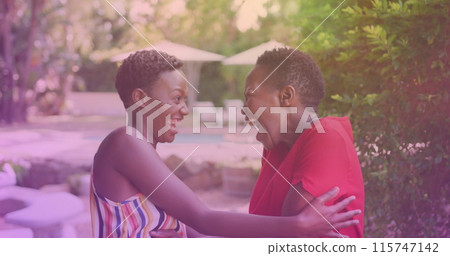 Two african american sisters hugging each other at a resort Two african american sisters hugging each other at a resort 115747142