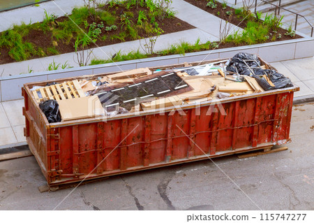 Garbage metal container is used for disposal construction waste during construction of house 115747277