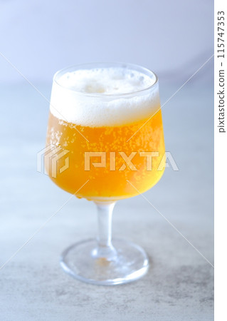 A glass of chilled beer with fine foam 115747353
