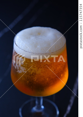 A glass of chilled beer with fine foam 115747354