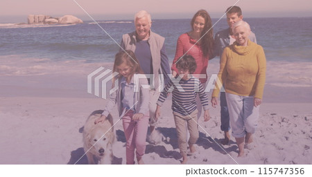 Caucasian three generation family with pet dog walking together in the garden 115747356