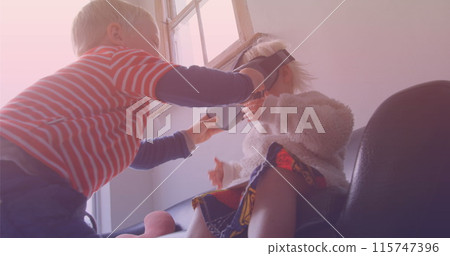 Image of smiling caucasian siblings playing with vr headset 115747396