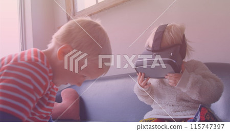 Image of smiling caucasian siblings playing with vr headset 115747397