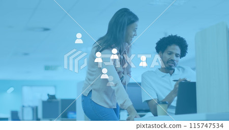 Image of social media user icons over diverse female and male coworkers in office 115747534