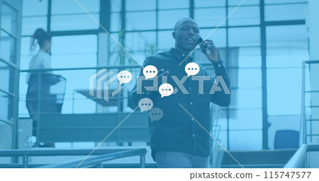 Image of social media reactions over african american man in office having call Image of social media reactions over african american man in office having call 115747577