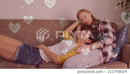 Image of hearts over caucasian female couple sitting on sofa Image of hearts over caucasian female couple sitting on sofa 115748024