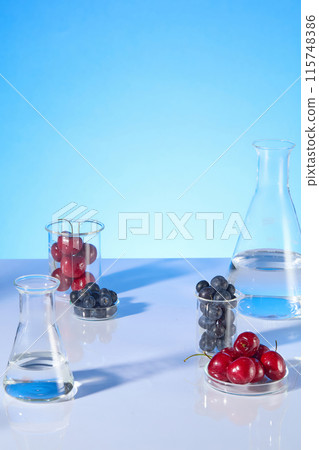 Creative photography from high angle view at a laboratory table top, against blue background. Experiment glassware displayed on the table leaving an empty space in center for showing product Creative photography from high angle view at a laboratory table top, against blue background. Experiment glassware displayed on the table leaving an empty space in center for showing product 115748386