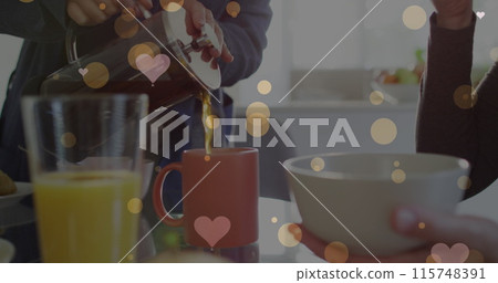 Image of hearts over caucasian female couple eating breakfast 115748391
