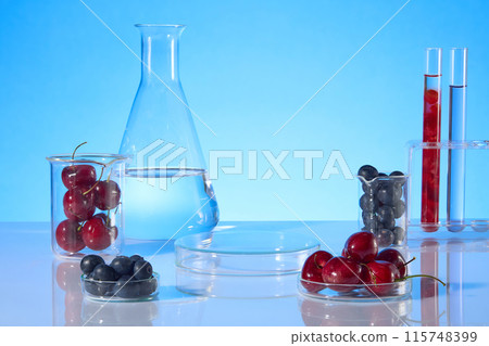 Creative template for advertising pics, blank glass round shape podium in center for displaying product of cosmetic or beauty care, which has fresh cherry and blueberry composition 115748399
