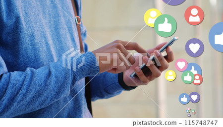 Close up of a man in a blue sweater checking his phone with digital image of like, heart and follow Close up of a man in a blue sweater checking his phone with digital image of like, heart and follow 115748747