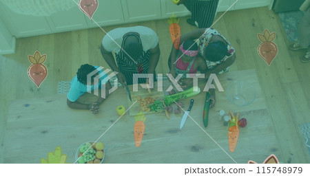 Image of vegetables falling over african american family cooking together in the kitchen 115748979