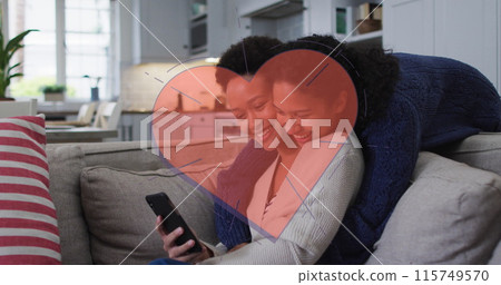 Image of red heart over two woman using smartphone Image of red heart over two woman using smartphone 115749570