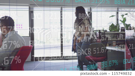 Image of financial data over diverse businesspeople working on laptops in office 115749832