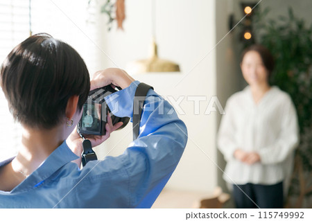 Female photographer and model taking a photo 115749992