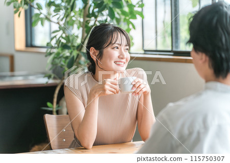 A smiling woman at a cafe, restaurant, or bar on a date 115750307