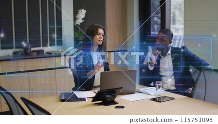 A business man and woman are discussing and using a laptop in a modern office A business man and woman are discussing and using a laptop in a modern office 115751093