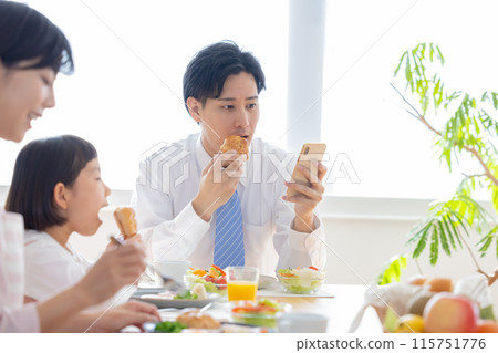 Family image: Father eating breakfast with his family 115751776