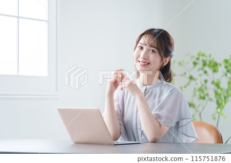Businesswoman working on a computer in the office (female, casual business) 115751876
