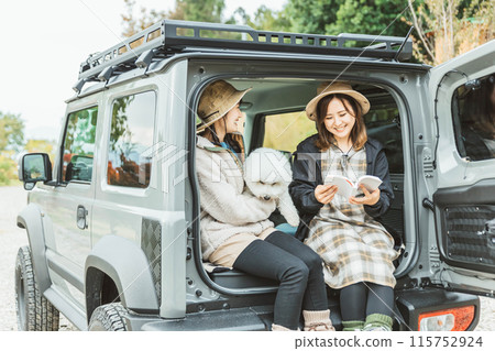 Women, friends, best friends in outdoor fashion driving with their pet dog Women, friends, best friends in outdoor fashion driving with their pet dog 115752924