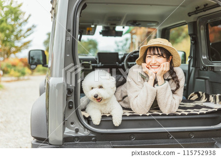 Young Asian woman going camping, hiking or driving with her dog or pet Young Asian woman going camping, hiking or driving with her dog or pet 115752938