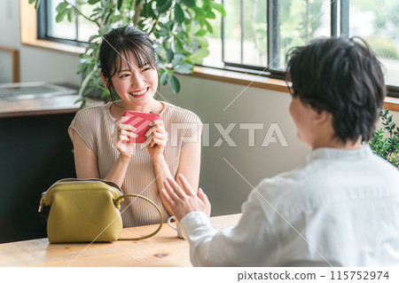 A smiling woman at a cafe, restaurant, or bar on a date 115752974
