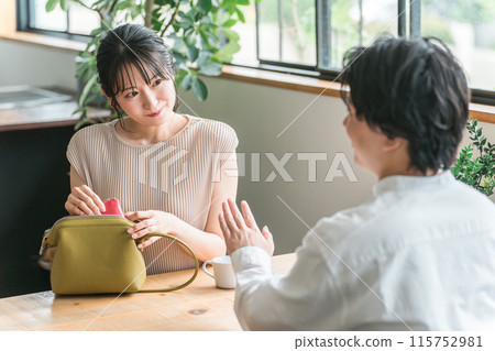 A smiling woman at a cafe, restaurant, or bar on a date 115752981