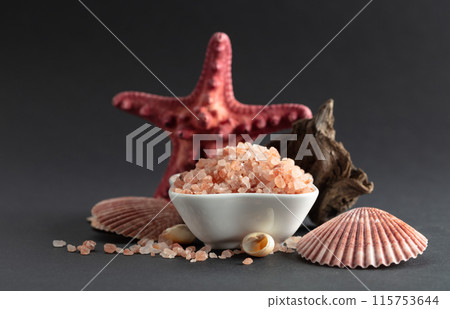 Pink himalayan salt with snags and seashells on a black background. 115753644