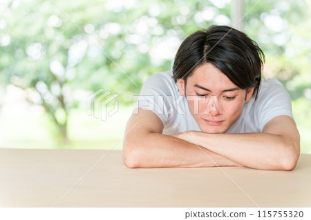 身穿鮮綠色背景白色 T 恤的亞洲年輕男子 身穿鮮綠色背景白色 T 恤的亞洲年輕男子 115755320