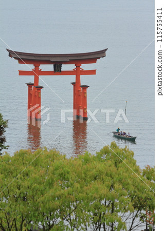 The large torii gate of Itsukushima Shrine and the Torokaibune boats seen from the Momiji Walkway The large torii gate of Itsukushima Shrine and the Torokaibune boats seen from the Momiji Walkway 115755411