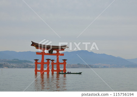 Tourists looking at the large torii gate of Itsukushima Shrine from a boat 115756194