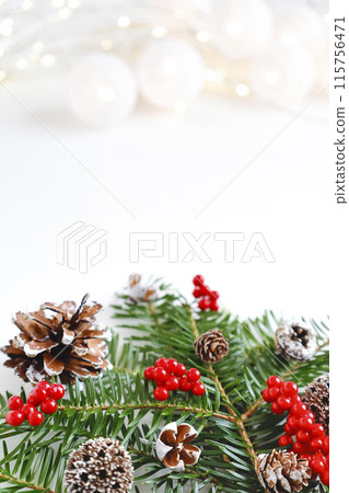 Christmas-themed swag and glittering material on a white background 115756471