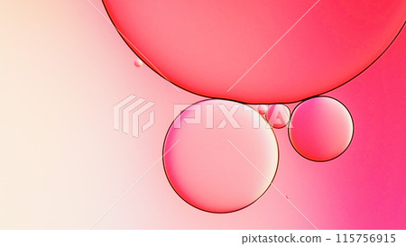 macrophotography of oil and water on gradient pink to white abstract background 115756915