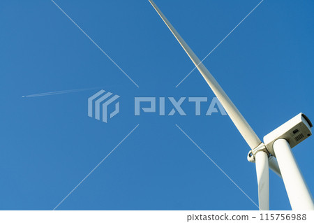Wind turbine and plane in the blue sky Wind turbine and plane in the blue sky 115756988
