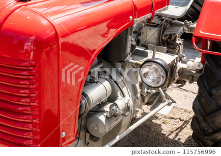 Red retro old tractor close up Red retro old tractor close up 115756996