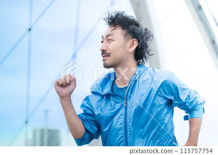 Profile of a smiling man running - Image of physical activity such as a marathon 115757754