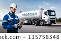 Man with digital tablet on a background of hydrogen tank trailer. 115758348