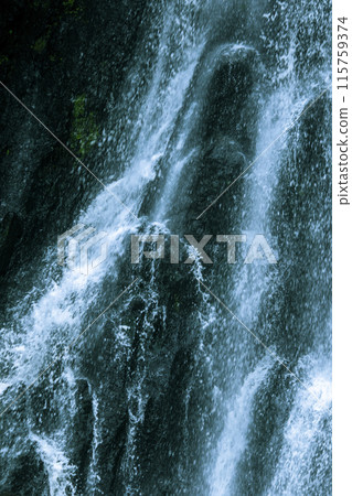The water flows down from the rock cliff. It hits the cliff and creates mist 115759374