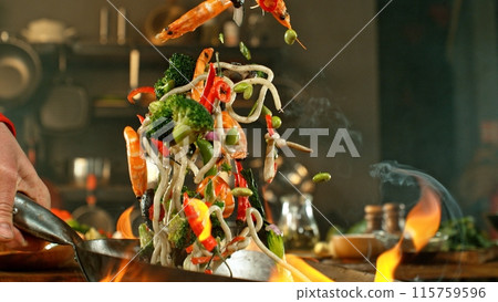Freeze Motion of Wok Pan with Flying Asian Meal in the Air. 115759596