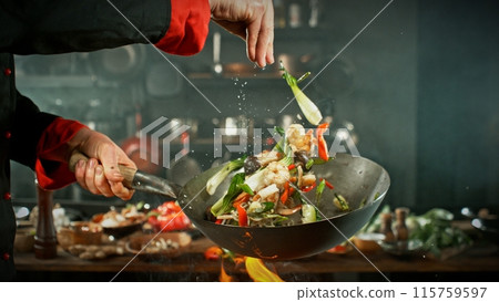 Freeze Motion of Wok Pan with Flying Asian Meal in the Air. 115759597