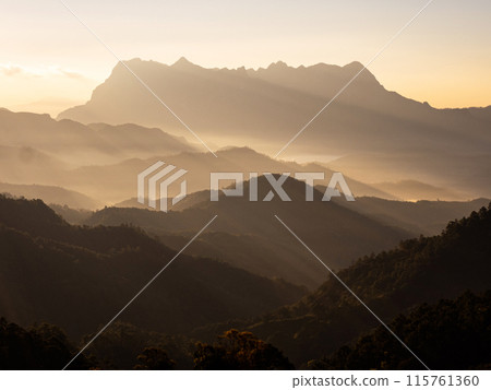 Doi Luang Chiang Dao mountain at dawn with golden hour sunrise sky. Chiang Mai - Thailand Doi Luang Chiang Dao mountain at dawn with golden hour sunrise sky. Chiang Mai - Thailand 115761360