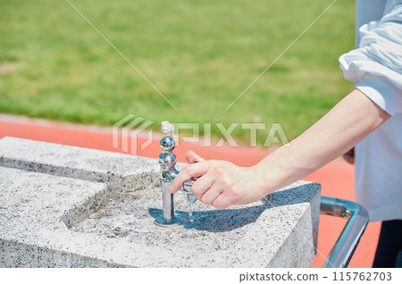 Park faucet, woman's hand, water, summer Park faucet, woman's hand, water, summer 115762703