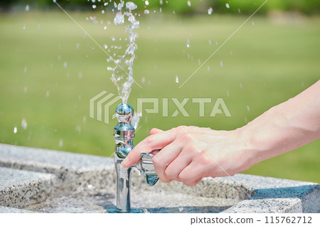 Park faucet, woman's hand, water, summer 115762712