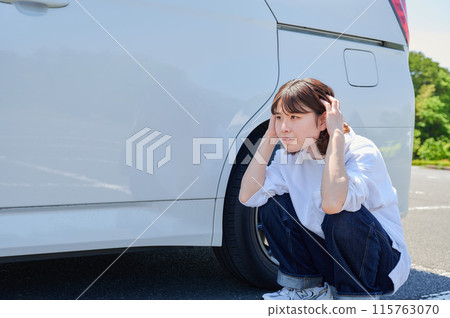 Woman holding her head in front of her car, flat tire, trouble Woman holding her head in front of her car, flat tire, trouble 115763070